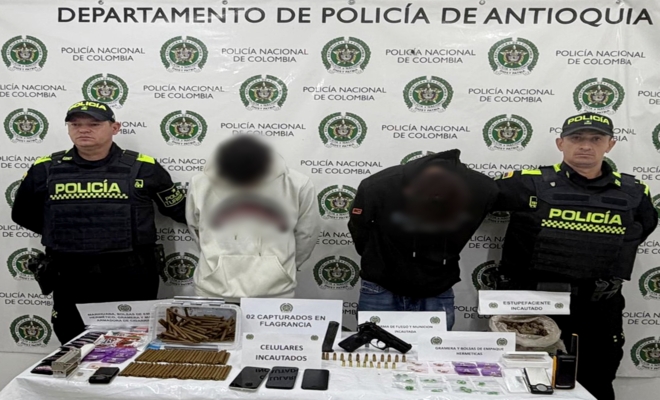 Dos polic&iacute;as custodian a dos capturados, una arma y estupefacientes incautados